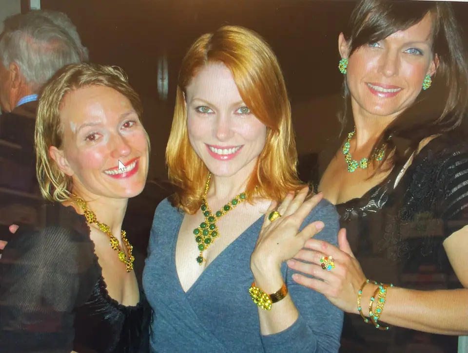 Three women at a party wearing Swoboda jade and peridot necklaces, rings and bracelets
