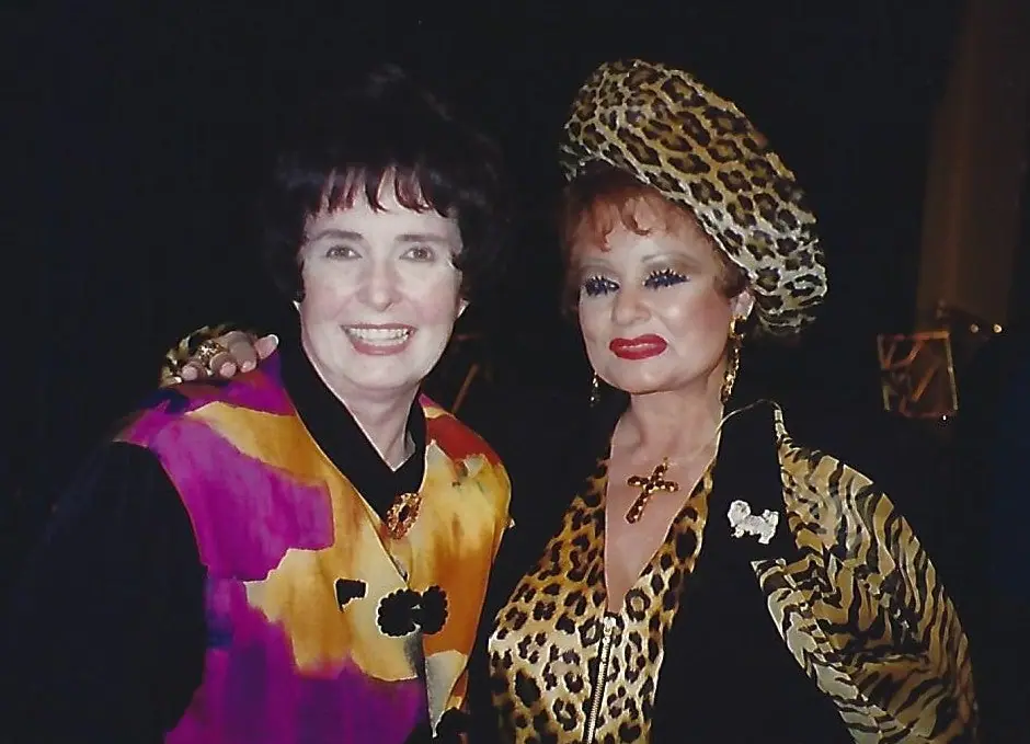 Margaret O'Brien and Tammy Faye Bakker posing together, both wearing brooches